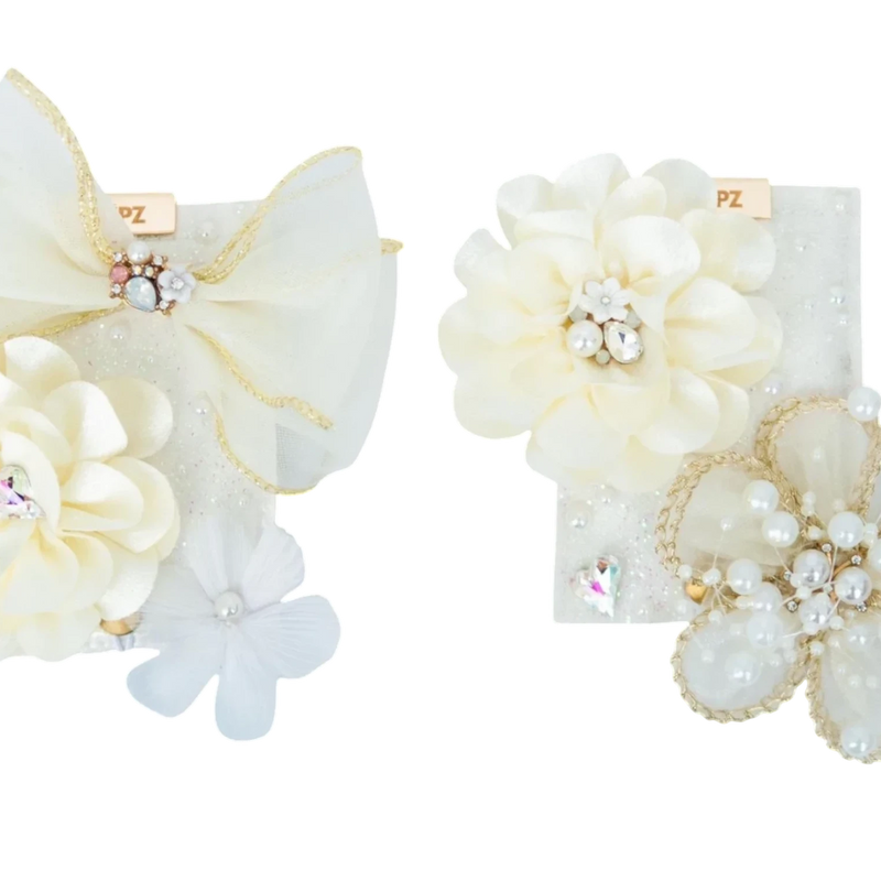 LŪPZ Champagne hair clips with ivory fabric flowers, pearls, rhinestones, and gold trim. Perfect for celebrations.
